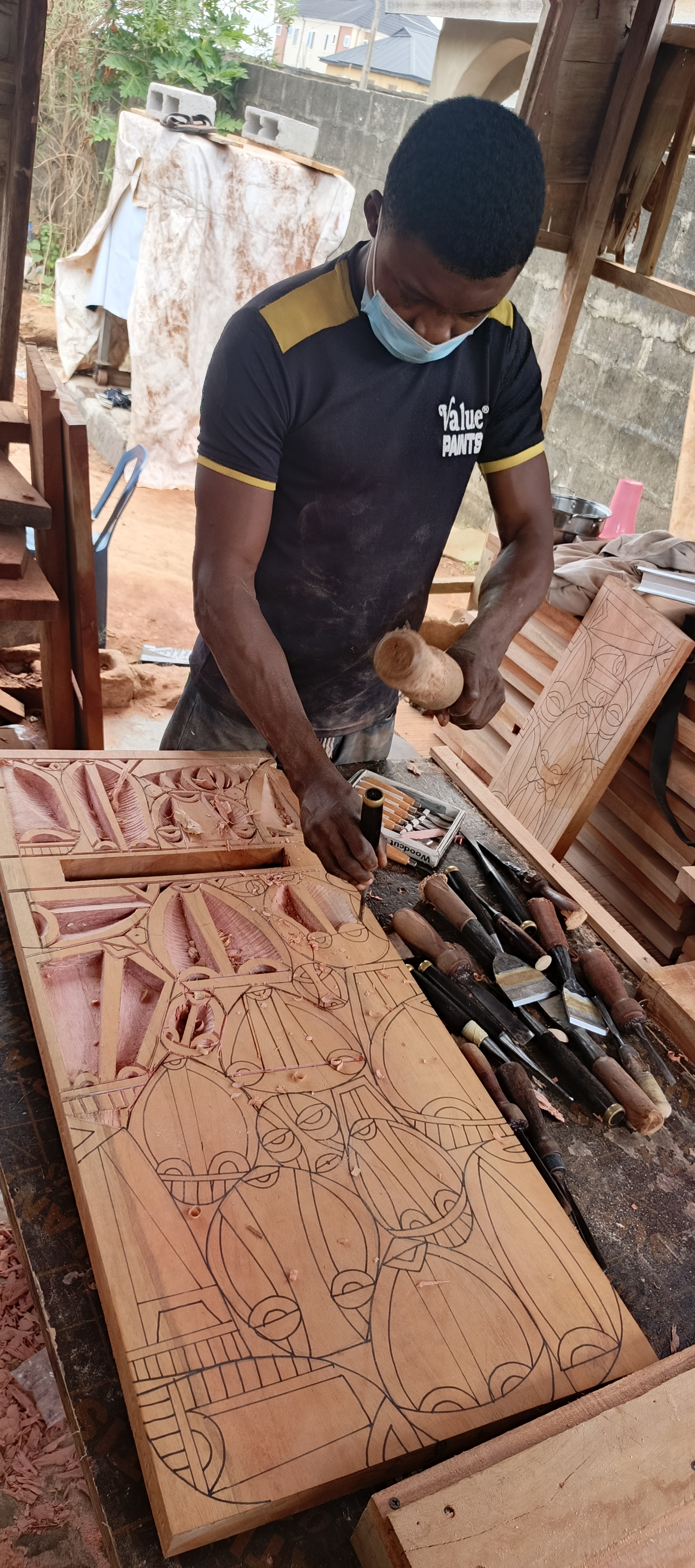 Artist carving wood in the studio